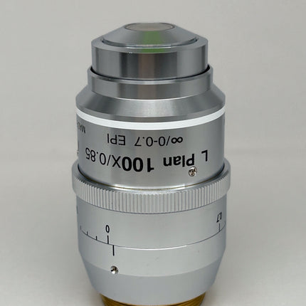 Nikon L Plan EPI CR 100x0.85 ∞/0-0.7 OFN25 MUE35900 Objective lens shown in a silver finish.