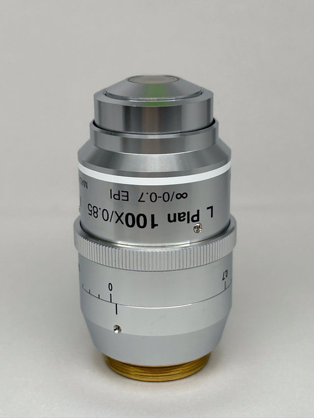 Nikon L Plan EPI CR 100x0.85 ∞/0-0.7 OFN25 MUE35900 Objective lens shown in a silver finish.