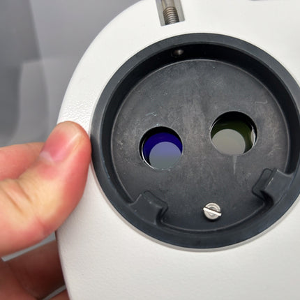 Close-up of Leica Documentation Photo Tube HD Camera Port 10446308 showing lens openings and hand holding the device.