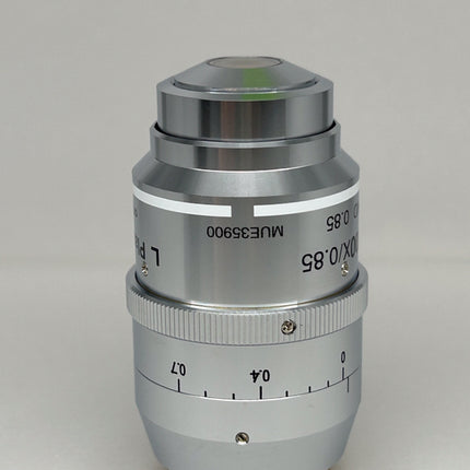 Nikon L Plan EPI CR 100x0.85 ∞/0-0.7 OFN25 MUE35900 Objective lens with scale and adjustment ring.