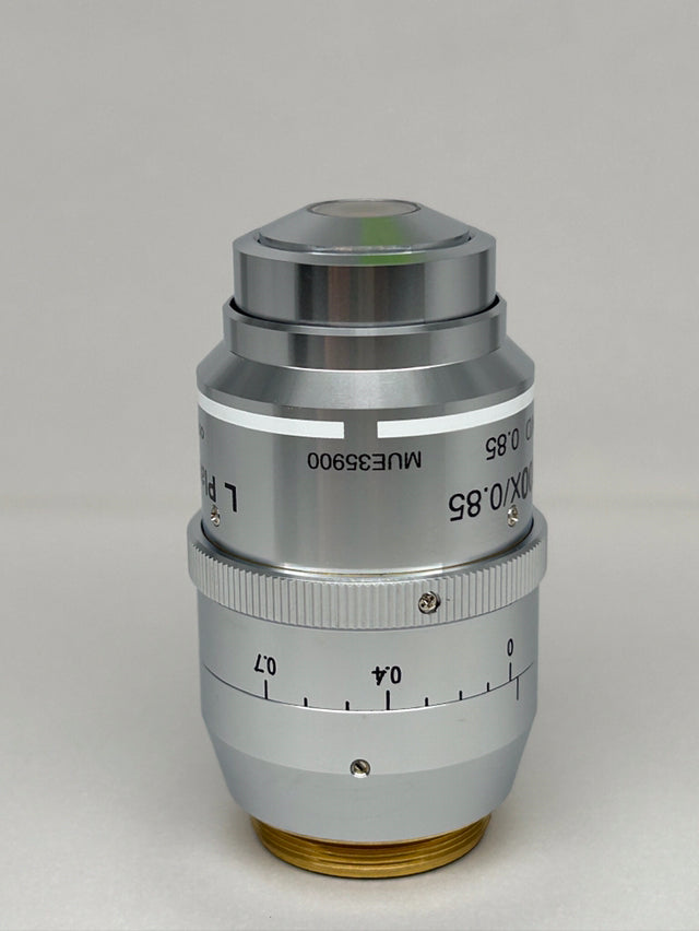 Nikon L Plan EPI CR 100x0.85 ∞/0-0.7 OFN25 MUE35900 Objective lens with scale and adjustment ring.