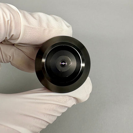 Close-up view of Olympus PlanApo N 60x1.40 Oil SC ∞/0.17 UIS2 A-Line Objective held by a gloved hand.