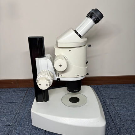 Leica MZ16 Stereo Microscope W/ 10X21B Eyepieces and PLANAPO 1.0x Objective on a flat surface.