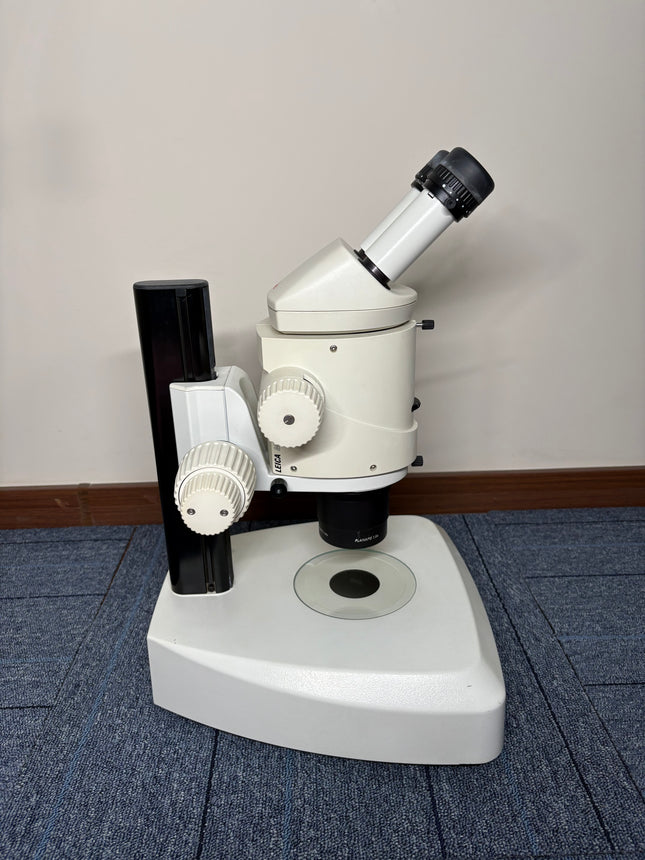 Leica MZ16 Stereo Microscope W/ 10X21B Eyepieces and PLANAPO 1.0x Objective on a flat surface.