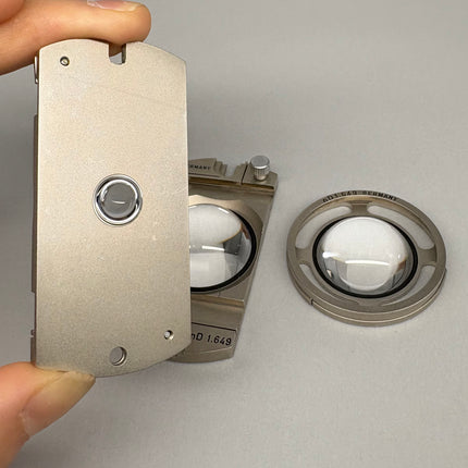 Parts of Leitz POL Microscope Fedorov Stage – n_D 1.516 / 1.554 / 1.649 with optical lenses and stage components in hand.