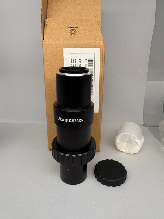 Leica Microscope C-mount Camera Adapter 0.63x 10447367 in open box with components and packaging.
