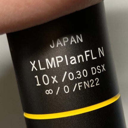 Olympus XLMPlanFL N 10x0.30 ∞/0 DSX Infinity Microscope Objective label close-up showing specifications.