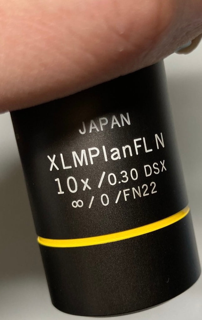 Olympus XLMPlanFL N 10x0.30 ∞/0 DSX Infinity Microscope Objective label close-up showing specifications.