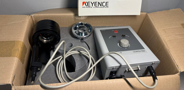 Keyence VH-R1 Motorized 3D Rotation Controller with Ring Adapter Mint in original packaging with components laid out.