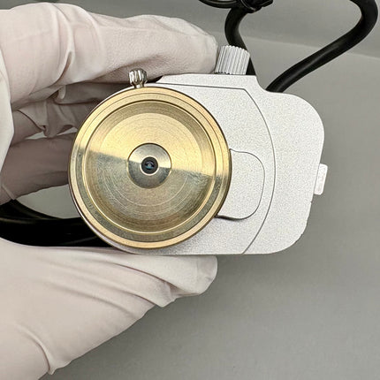 Leica Objective HC PL APO 93x/1,30 GLYC motCORR STED WHITE 506417 in hand with brass detailing.