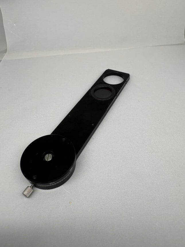 Leica Microscope Reflected Light Polarizer Rotatable Slider 555079 lying on a flat surface, showcasing its design.