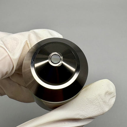 Olympus MPlanApo 20x0.60 ∞/0 RMS Objective held in gloved hand, showing detail of objective lens top.