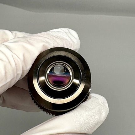 Olympus LUCPlanFL N 20x0.45 Ph1 ∞/0-2/FN22 UIS2 Objective held in a gloved hand, showcasing its optical lens.