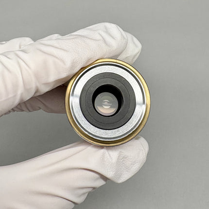 Zeiss EC Plan-NEOFLUAR 10x/0.3 Microscope Objective 420340-9900 M27 in hand, highlighting the optical element.