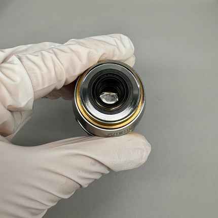 Zeiss C-APOCHROMAT 40x1.2 W Korr UV-VIS -IR ∞/0.14-0.19 Objective 421767-9971-711 held in gloved hand.