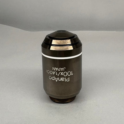 Olympus PlanApo 100x1.40 Oil ∞/0.17 RMS Thread Microscope Objective on gray background