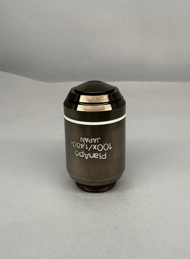 Olympus PlanApo 100x1.40 Oil ∞/0.17 RMS Thread Microscope Objective on gray background