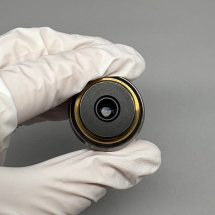 Olympus PlanApo 100x1.40 Oil ∞/0.17 RMS Thread Microscope Objective held in gloved hand.