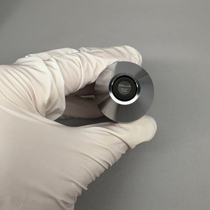 Nikon N Plan Apo λ Lambda 10x0.45 ∞/0.17 WD4.0 MRHD00105 M25 microscope objective held in gloved hand.