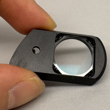 Nikon Plan Apo 100 oil DIC Nomarski Prism Slider f/ Plan Apo 100x oil Objective component held in hand.