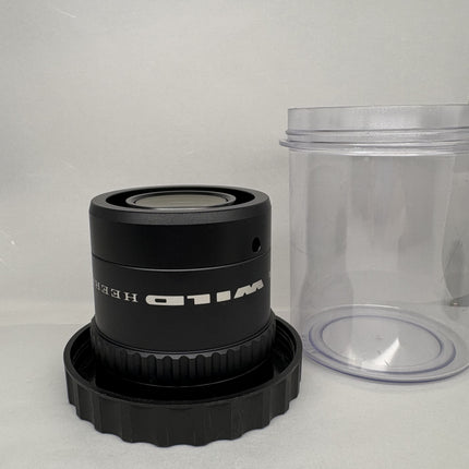 Leica WILD HEERBRUGG PLANAPO 1.6x 472650 for Stereo Microscopes on display with lens container.