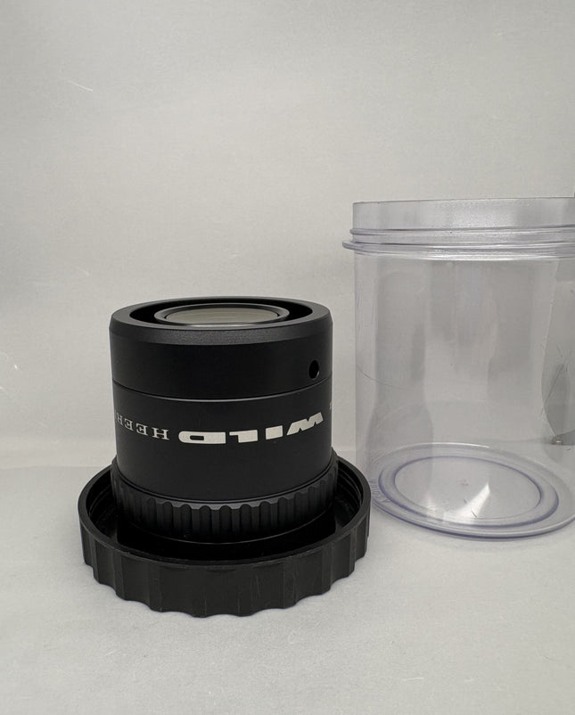 Leica WILD HEERBRUGG PLANAPO 1.6x 472650 for Stereo Microscopes on display with lens container.