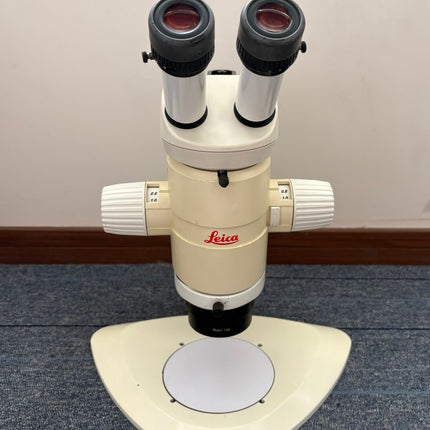 Leica MZ12 Stereo Microscope W/ 10X21B Eyepieces and PLAN 1.0x Objective front view on a table.
