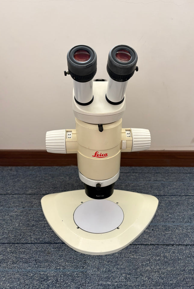 Leica MZ12 Stereo Microscope W/ 10X21B Eyepieces and PLAN 1.0x Objective front view on a table.