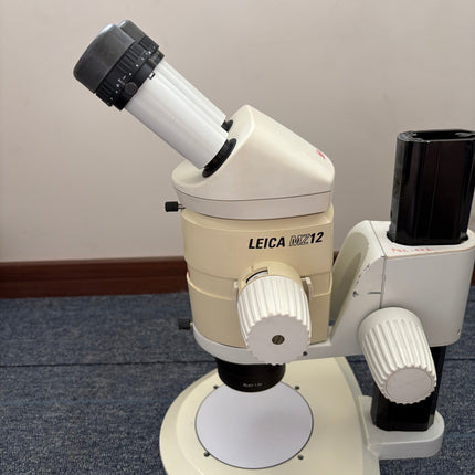 Leica MZ12 Stereo Microscope W/ 10X21B Eyepieces and PLAN 1.0x Objective showing eyepiece and zoom body in good condition.