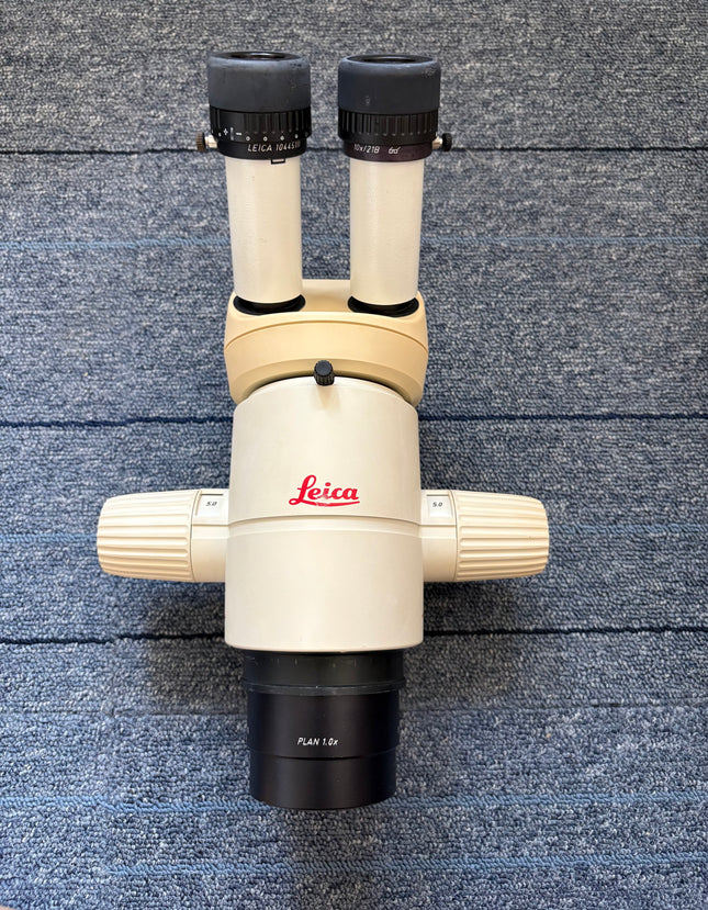 Leica MZ7.5 Stereo Microscope W/10X21B Eyepieces W/PLAN 1.0x Objective shown from above on a blue surface.