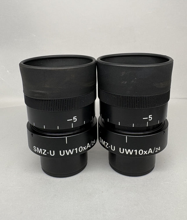 Pair of Nikon SMZ-U UW10xA/24 Microscope Eyepieces on display, featuring black barrels and 10x magnification.