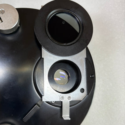 Olympus 1.4 Nomarski DIC NIC & phase contrast universal condense w/1.25x intermediate attachment  held in hand to showcase optical features.shown from the side, displaying colorful filters.