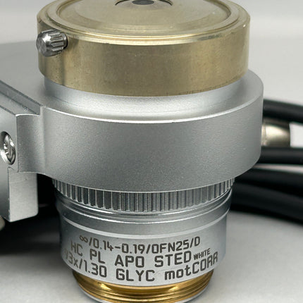 Leica Objective HC PL APO 93x/1,30 GLYC motCORR STED WHITE 506417 close-up view showing optical components and details.