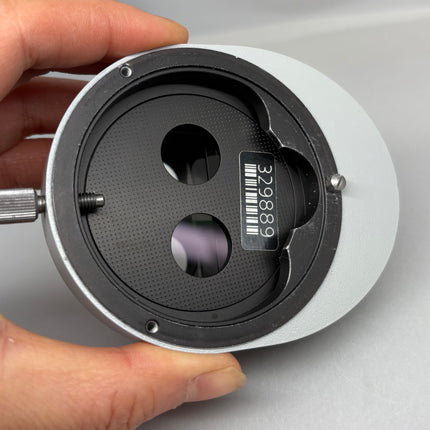 Carl Zeiss OPMI Angle Adjustment Ring 329889 for OPMI microscopes systems held in hand to showcase optical features