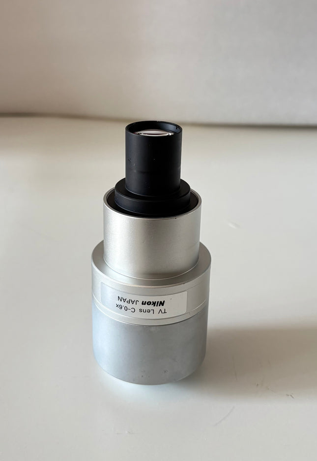 Nikon TV Lens C-0.6x MQD42060 C-Mount Camera/Photo Adapter on a white background.