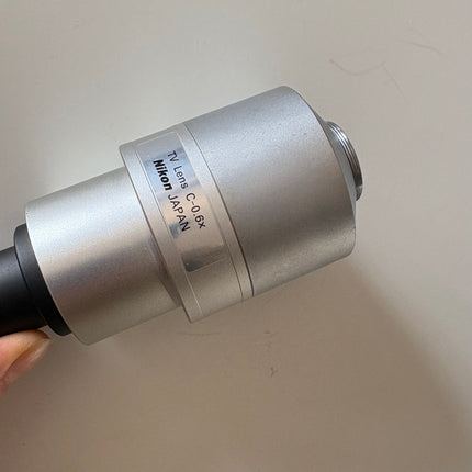Nikon TV Lens C-0.6x MQD42060 C-Mount Camera/Photo Adapter showing nikon logo details 