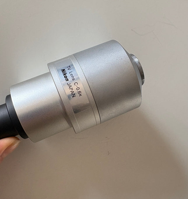 Nikon TV Lens C-0.6x MQD42060 C-Mount Camera/Photo Adapter showing nikon logo details 