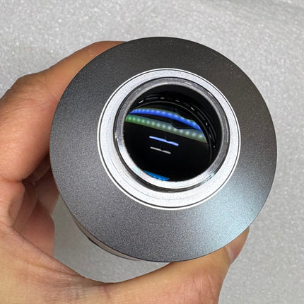 Nikon TV Lens C-0.6x MQD42060 C-Mount Camera/Photo Adapter held in hand to showcase optical features