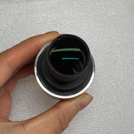 Nikon TV Lens C-0.35x C-Mount Camera/Photo Adapter shown in close-up view, highlighting optical condition.