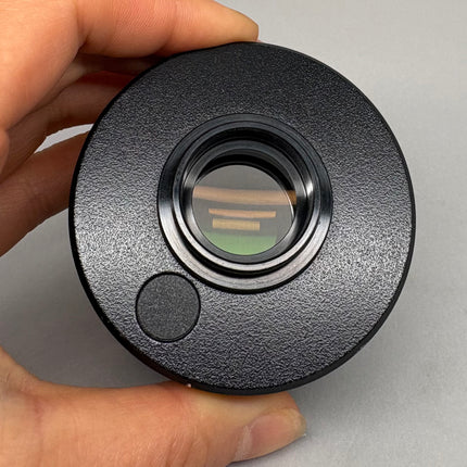 Olympus U-TV0.5XC-3 Microscope C-mount Camera Adapter in hand, showing front view and lens.