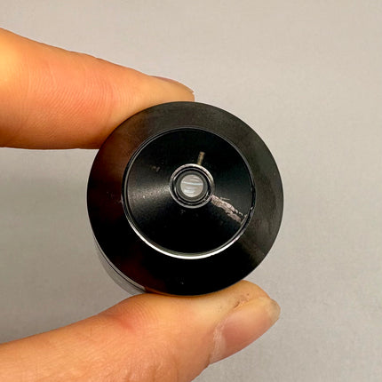 Olympus UPlanSApo 20x0.75 ∞/0.17/FN26.5 Microscope UIS2 Objective held by a hand, showcasing the top view.