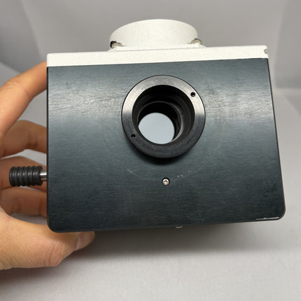 Nikon Y-QT dual camera port adapter for Eclipse held in hand, showcasing the front view and camera port.
