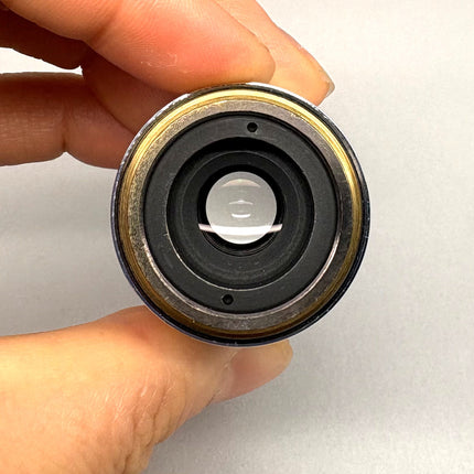 Nikon Microscope Objective LU Plan Fluor 20X /0.45 ∞/0 EPI M25 lens held in hand, showcasing the detailed optical structure.