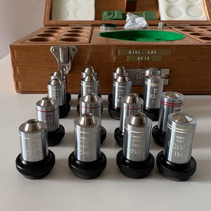 Rare New Old Stock Olympus Phase Contrast NH NM PL PLL Objectives RMS displayed in a wooden case with compartments.