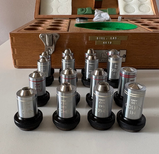Rare New Old Stock Olympus Phase Contrast NH NM PL PLL Objectives RMS displayed in a wooden case with compartments.