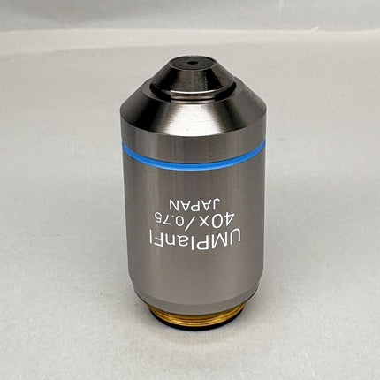 Olympus UMPlanFl 40x0.75 ∞/0 Microscope Objective showing the metallic body with label.