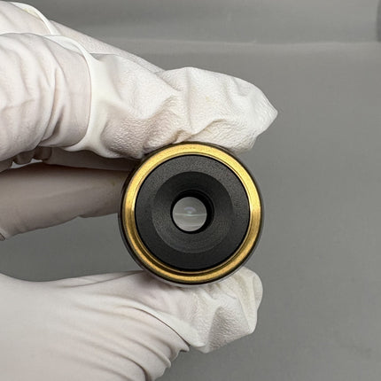 Olympus UMPlanFl 40x0.75 ∞/0 Microscope Objective held in gloved hand, showcasing the lens and RMS thread.