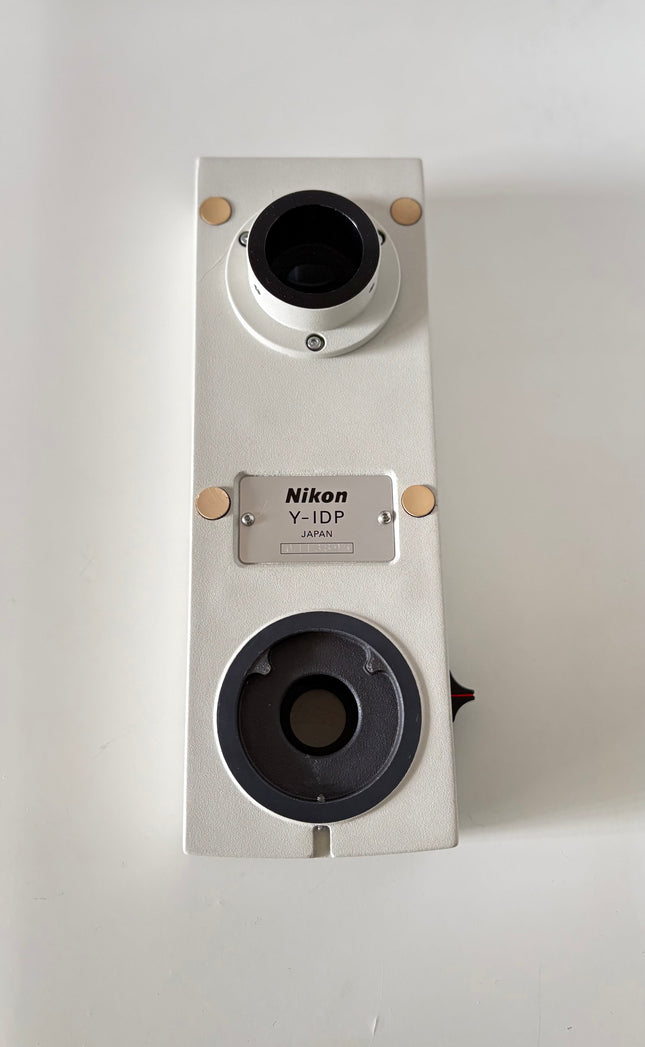 Nikon Y-IDP Dual Microscope Camera Port showing the top view with multiple ports and branding.