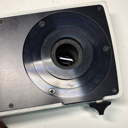 Close-up of the Nikon Y-IDP Dual Microscope Camera Port, showcasing its optical interface and design.