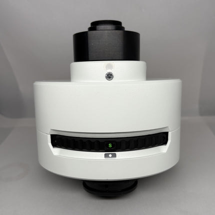 Olympus U-TVCAC C-mount video magnification change unit (IR-compliant) front view, showing turret and focus elements.